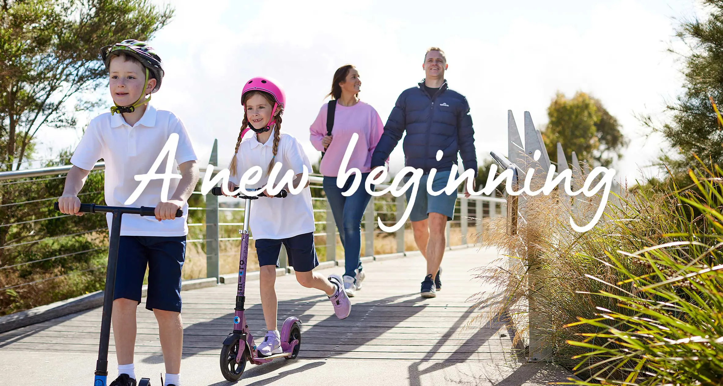 A family walking and Kids scooting across a bridge on their way to a new house and community Melbourne
