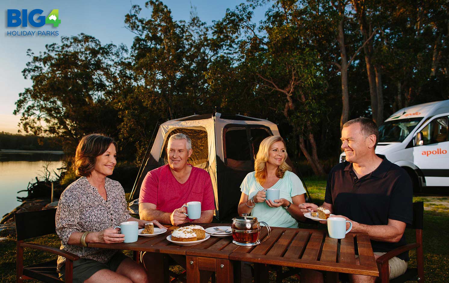 Friends, enjoy a dinner party at a luxury campsite with their campervan at a beautiful Victorian location.