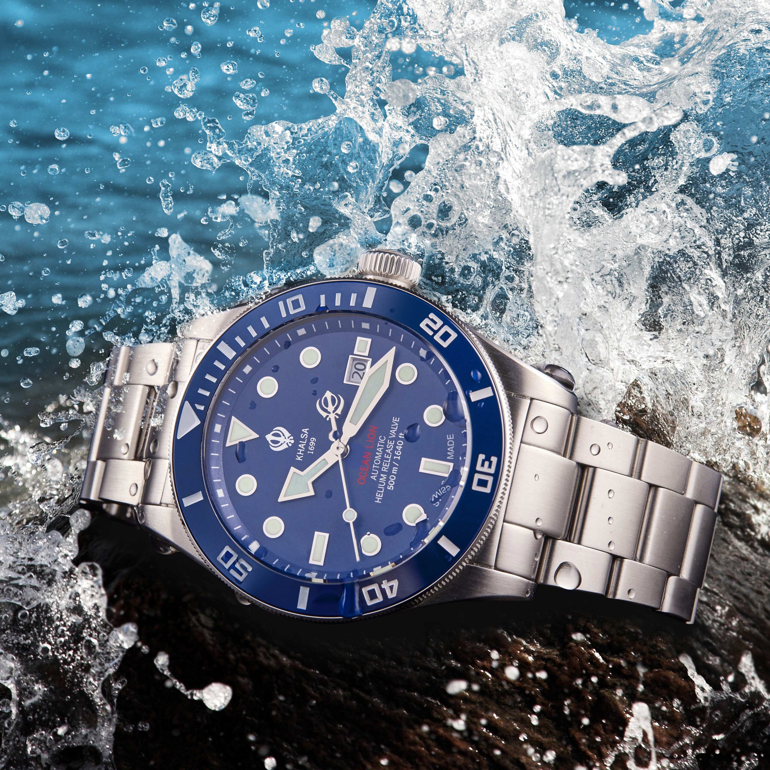 Luxury Swiss made watch for diving placed on rock with water splashing over it